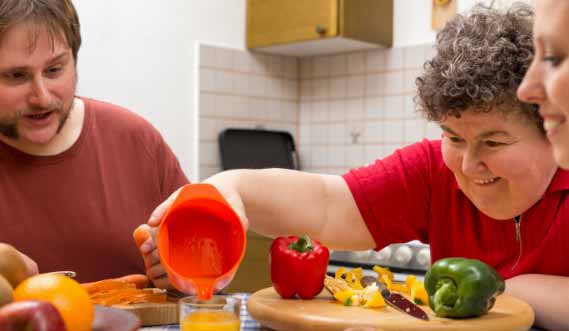 A group of people prepare food with the help of a clinical dietitian