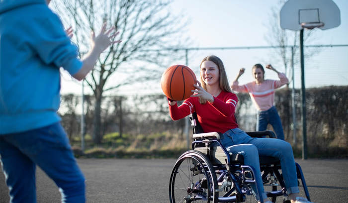 A girl plays wheelchair basketball