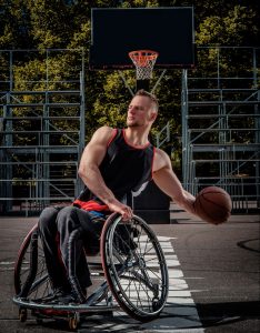 Young man with a spinal cord injury playing wheelchair basketball